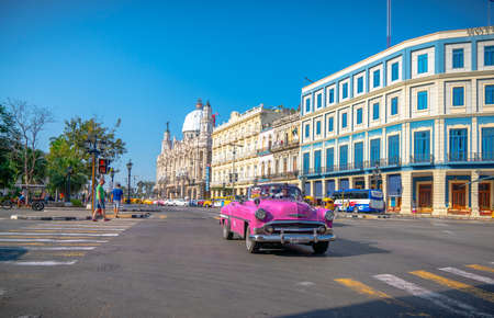 Retro car as taxi with tourists in Havana, Cuba. Captured near Gran Teatro de La Habana, El Capitolio and Paseo del Prado in spring 2019のeditorial素材