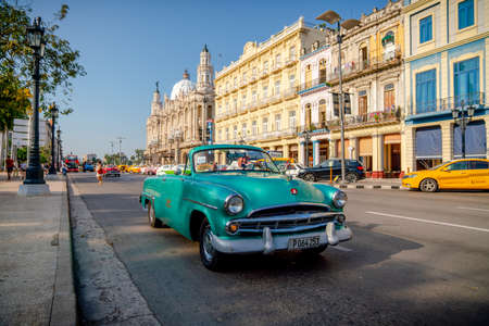 Retro car as taxi with tourists in Havana, Cuba. Captured near Gran Teatro de La Habana, El Capitolio and Paseo del Prado in spring 2019のeditorial素材