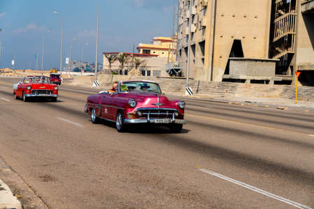 Retro taxi car with tourists in Havana, Cuba. Captured on Malecon roadway in spring 2019のeditorial素材