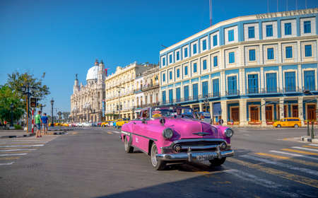 Retro car as taxi with tourists in Havana, Cuba. Captured near Gran Teatro de La Habana, El Capitolio and Paseo del Prado in spring 2019のeditorial素材
