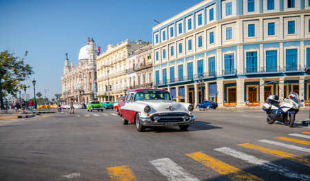 Retro car as taxi with tourists in Havana, Cuba. Captured near Gran Teatro de La Habana, El Capitolio and Paseo del Prado in spring 2019のeditorial素材
