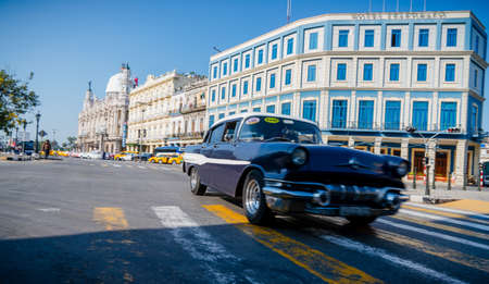 Retro car as taxi with tourists in Havana, Cuba. Captured near Gran Teatro de La Habana, El Capitolio and Paseo del Prado in spring 2019のeditorial素材