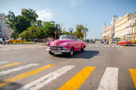 Retro car as taxi with tourists in Havana, Cuba. Captured near Gran Teatro de La Habana, El Capitolio and Paseo del Prado in spring 2019のeditorial素材