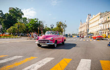 Retro car as taxi with tourists in Havana, Cuba. Captured near Gran Teatro de La Habana, El Capitolio and Paseo del Prado in spring 2019のeditorial素材