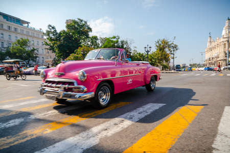Retro car as taxi with tourists in Havana, Cuba. Captured near Gran Teatro de La Habana, El Capitolio and Paseo del Prado in spring 2019のeditorial素材