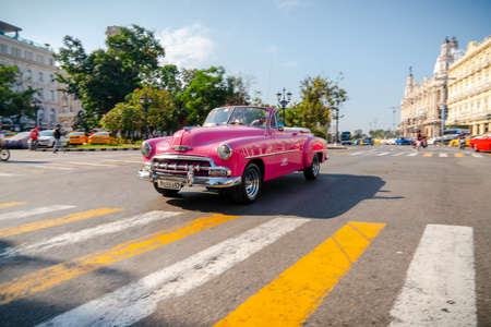Retro car as taxi with tourists in Havana, Cuba. Captured near Gran Teatro de La Habana, El Capitolio and Paseo del Prado in spring 2019のeditorial素材