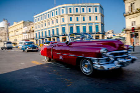 Retro car as taxi with tourists in Havana, Cuba. Captured near Gran Teatro de La Habana, El Capitolio and Paseo del Prado in spring 2019のeditorial素材