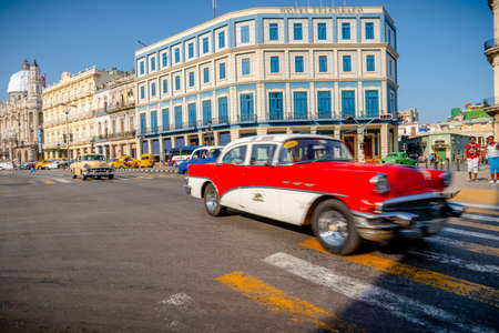 Retro car as taxi with tourists in Havana, Cuba. Captured near Gran Teatro de La Habana, El Capitolio and Paseo del Prado in spring 2019のeditorial素材