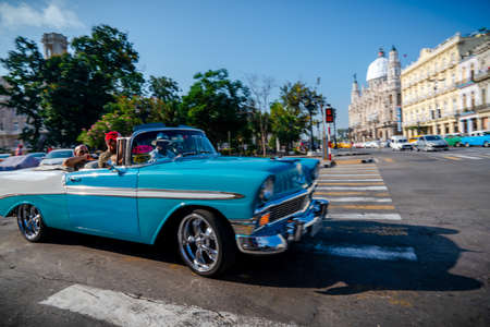 Retro car as taxi with tourists in Havana, Cuba. Captured near Gran Teatro de La Habana, El Capitolio and Paseo del Prado in spring 2019のeditorial素材