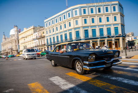 Retro car as taxi with tourists in Havana, Cuba. Captured near Gran Teatro de La Habana, El Capitolio and Paseo del Prado in spring 2019のeditorial素材