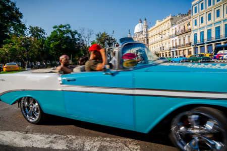 Retro car as taxi with tourists in Havana, Cuba. Captured near Gran Teatro de La Habana, El Capitolio and Paseo del Prado in spring 2019のeditorial素材