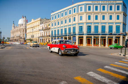 Retro car as taxi with tourists in Havana, Cuba. Captured near Gran Teatro de La Habana, El Capitolio and Paseo del Prado in spring 2019のeditorial素材