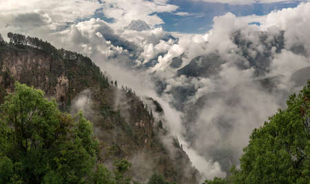 Nilgiri summit and cloudy Himalayas. Monsoon time in Nepalの写真素材