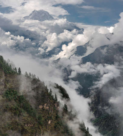 Nilgiri summit and cloudy Himalayas. Monsoon time in Nepalの写真素材