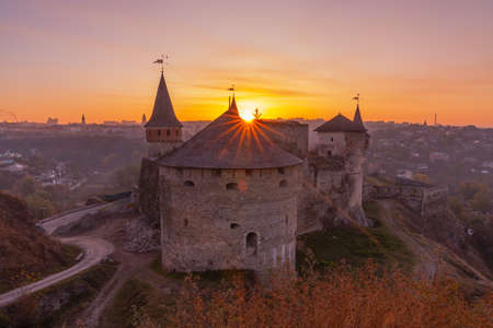 medieval castle or stronghold in Kamianets-Podilskyi, Ukraine and beautiful sunset. Tourism in Europeのeditorial素材