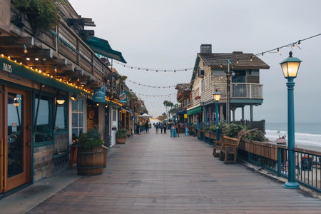 Charming coastal boardwalk with shops and dining, creating a relaxed atmosphere by the ocean.の素材