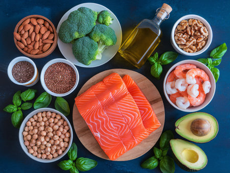 A colorful display of healthy food items including salmon, broccoli, nuts, and herbs on a dark surface.の素材