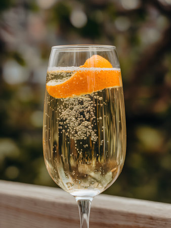 A sparkling drink with a slice of orange, creating a refreshing and delightful beverage experience.の素材