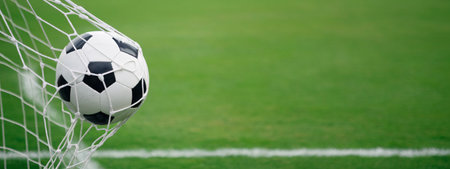Soccer ball nestled in the net, capturing the excitement of the game.の素材
