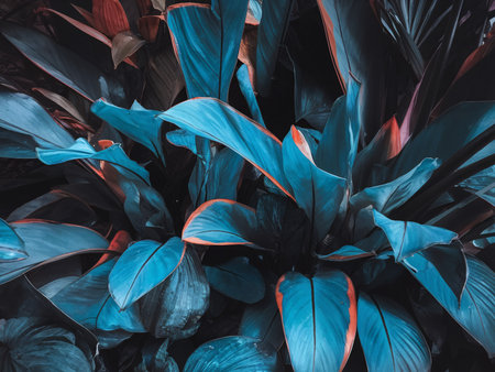 Vibrant tropical leaves with shades of blue and hints of orange, creating a serene and lush atmosphere.の素材