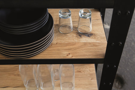 empty glass jars on a wooden table in a restaurant, vintage tone
