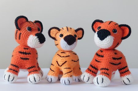Handmade knitted stuffed animals â Tigers family on white backgroundの写真素材
