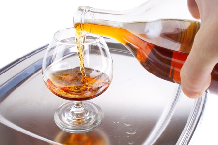 Pouring cognac into the sniffer on the serving trayの写真素材