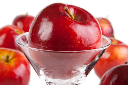 Red apples, one apple in drink glassの写真素材