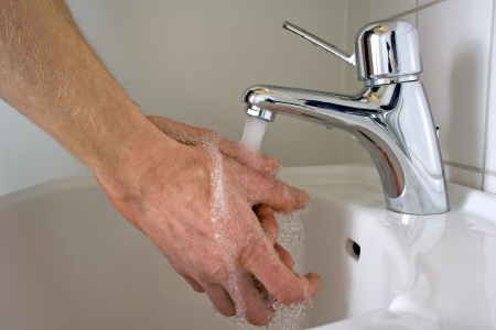 Man washing his hands with water and soapの写真素材