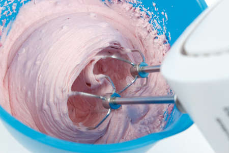 Making strawberry mousse with electric mixerの写真素材