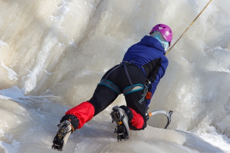 Female ice climber in icy mountの写真素材