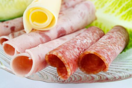 Rolled cold cuts on dish, shallow dof