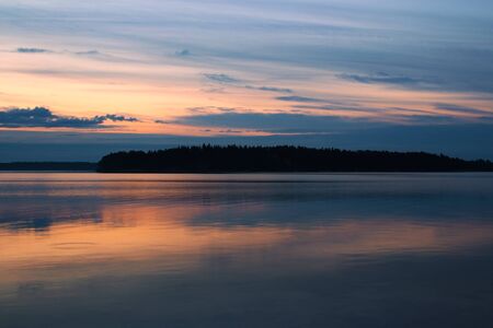 Summer night twilight in Finland with reflectionsの写真素材