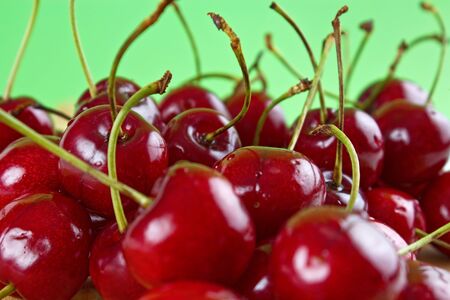 Fresh cherries with green background, shallow dof