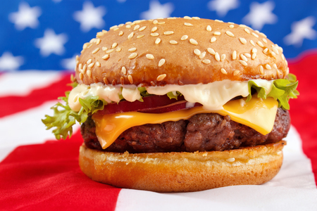 Cheeseburger with mayonnaise on USA flagの写真素材
