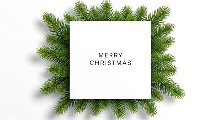 A blank white card with the words Merry Christmas printed in a textured font is framed by vibrant green fir branches, creating a festive and minimalist holiday greeting.の素材