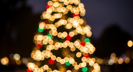 This image captures the magical ambiance of a decorated Christmas tree at night. The out-of-focus lights create a beautiful bokeh effect, evoking warmth and festive cheer.の素材
