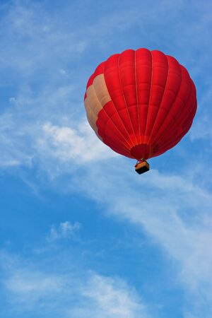 Red hot air balloon in skyの写真素材