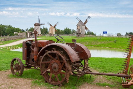 Old tractor and wooden windmills in Angla  Saaremaa island, Estonia  Europeの写真素材