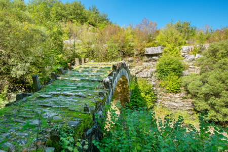 One-arch stone bridge of Captain Arkouda on the river of Xiropotamos. Central Zagori. Epirus, Greeceの写真素材