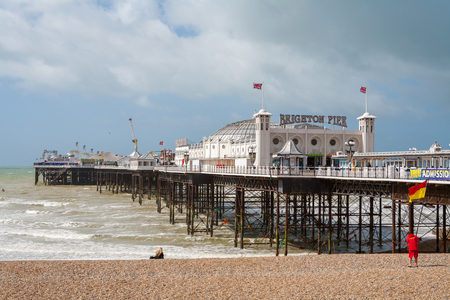 BRIGHTON, EAST SUSSEX, ENGLAND - JUNE 15, 2013: View of Brighton pier and pebble beachのeditorial素材