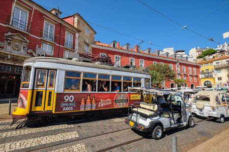 LISBON, PORTUGAL - SEPTEMBER 1, 2017: Historic tram 28 going by Largo Portas do Sol street in Alfama districtのeditorial素材