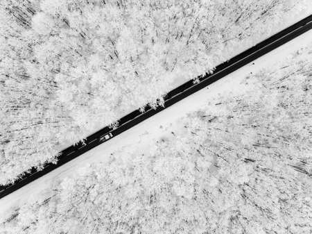 Road through snowy forestの写真素材