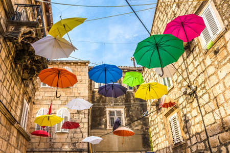 Croatia - island Korcula. The streets of the city of Korcula. Colorful umbrellas.の写真素材