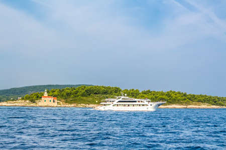Croatia - island of Hvar. A yacht sailing along the coast of the island of Hvarの写真素材