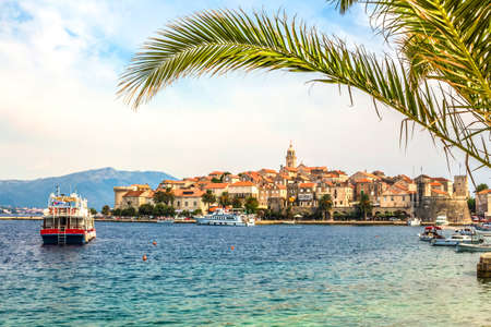 Croatia - island Korcula. The historic town of Korcula and palm leaf.の写真素材