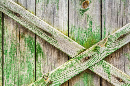 Old gate with boards. Old boards painted green. Structure of old boards.の写真素材
