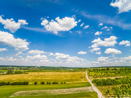 Rural landscape with road and sky. A dirt road, running to the horizon. Landscape with sky.の写真素材