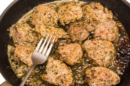 Pork fried in a pan. Frying meat on fat. Meat in spices.の写真素材
