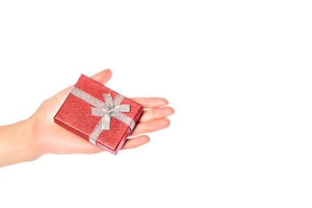 Hand with a gift for Christmas. Hand with a red gift box